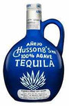 Hussongs Anejo Tequila 100% de Agave 750 ML bottle with blue clay jug design.