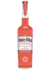 Bottle of Dulce Vida Grapefruit Tequila 750 ML with fresh grapefruit slices and a cocktail glass