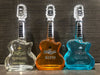 Rock N Roll Tequila Combo 750 ML bottles in guitar-shaped glass, featuring Platinum, Cristalino, and Mango flavors.